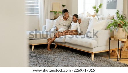Relax, child and mother watching tv on the sofa in the living room of their house together. Excited, African and young kid with a cartoon, film or movie with their mom on the couch of their house