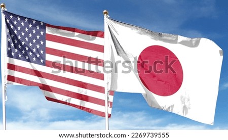 American flag and Japanese flag on cloudy sky. waving in the sky