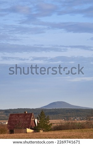 Lonely cottage, typical Czech small village house, or a weekend holiday home located in rural landscape countryside with Rip mountain in background