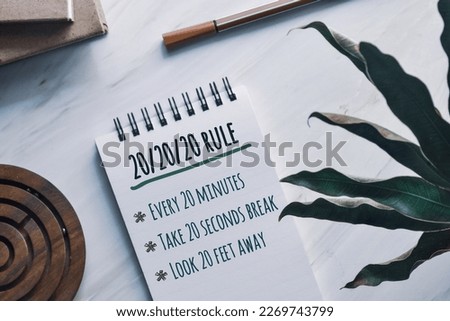 20 20 20 rule to prevent digital eye strain concept and key points on notepad. Top view.  Royalty-Free Stock Photo #2269743799