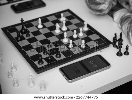chess board, photo of chess and clock on the table, strategic chess game. a closeup of a wooden chess board with white background