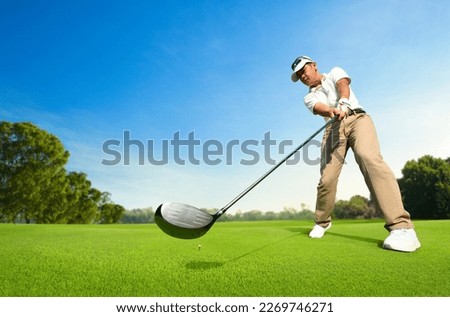 Motion action of golfer teeing off with drivers.