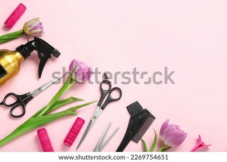 Hairdresser's tools with tulips on pink background. Hello spring
