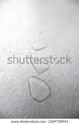 Detail of rainwater on a metal surface outdoors