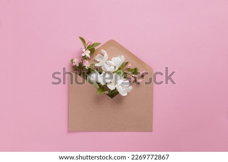 Craft envelope full of spring white fruit flowers flat lay Royalty-Free Stock Photo #2269772867