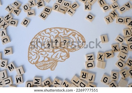 silhouette of brain, word IQ, wooden letters, intelligence quotient on wooden background, quantitative indicator expressing success, concept of level of mind, intellectual achievements testing Royalty-Free Stock Photo #2269777551
