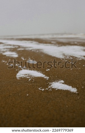 Snowy foot step on the beach