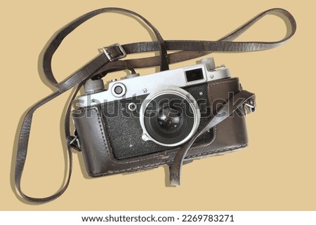 Old rangefinder vintage camera on yellow background