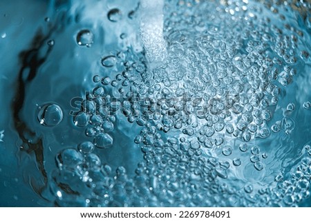 Water background. A jet of clean water. Background of air bubbles in water. The concept of clean water.