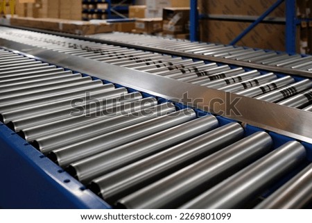 Conveyor belt inside a manufacturing site or distribution warehouse Royalty-Free Stock Photo #2269801099