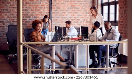 Business Team Working Together In Busy Multi-Cultural Office Royalty-Free Stock Photo #2269801461