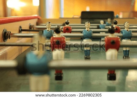 Table football, commonly called fuzboll or foosball (as in the German Fußball "football") and sometimes table soccer, is a table-top game that is loosely based on association football. Royalty-Free Stock Photo #2269802305