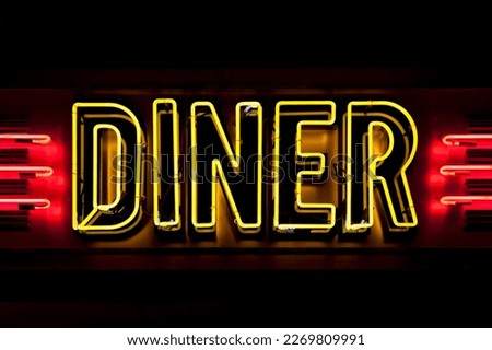Close-up on a neon light shaped into the word "Diner".