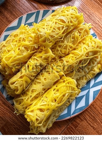 The picture of Roti Jala, Malaysian Traditional Food. You can eat Roti Jala with Chicken Curry.