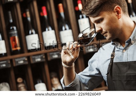 Bokal of red wine on background, male sommelier appreciating drink Royalty-Free Stock Photo #2269826049