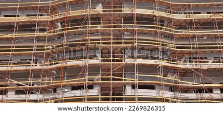 Construction work site with scaffold. Building reconstruction of the old habitation house Royalty-Free Stock Photo #2269826315