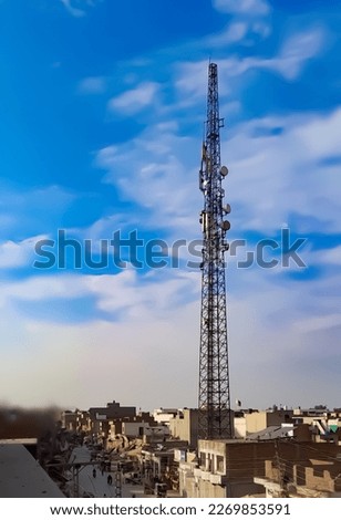 A photo taken from Manga Mandi, a city in Pakistan showing one tower blue sky background and stock photo 