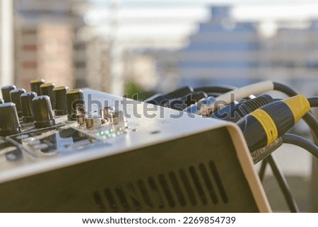 close up of outdoor music mixer controller with connected audio cables, copy space.