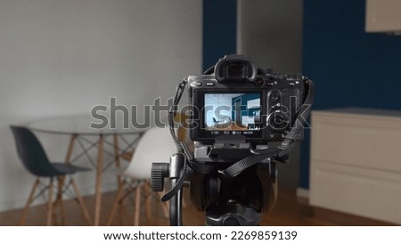 Man photographer taking pictures indoor in living room - real estate home photography and professional video to sell the house apartment - interior design and home staging Royalty-Free Stock Photo #2269859139