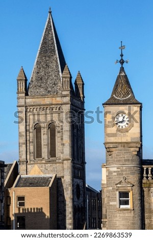 Old church tower, now part of a residential building, pictured with a clock tower, originally part of the Edinburgh Savings Bank building, in Stockbridge, Edinburgh.