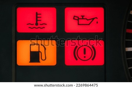 four controls on the dashboard of an old car - temperature, oil, fuel and breaks