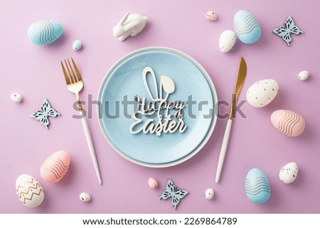 Easter celebration concept. Top view photo of blue plate with inscription happy easter cutlery pink white blue eggs ceramic easter bunny and butterflies on isolated lilac background