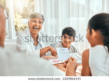 Education, cards and grandparents with children and letter lesson for language, study and alphabet. School, homework and help with family at table and teaching for language, literacy and phonics