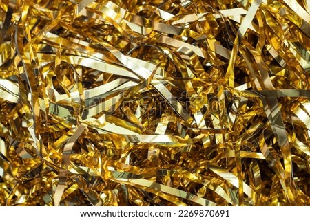 Festive gold tinsel strands. Glistening web banner or background for your design Royalty-Free Stock Photo #2269870691