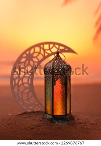 Ramadan Lantern on the beach with crescent moon shape during sunset, 2024 Islamic concept image, Eid Mubarak Greeting background Royalty-Free Stock Photo #2269876767