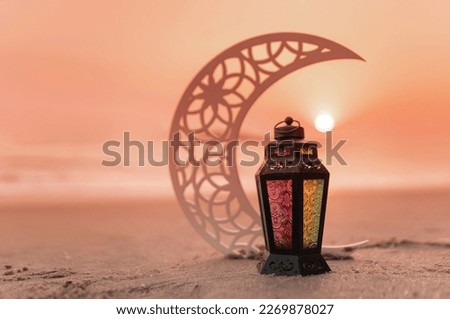 Lantern Lamp During sunset, Beautiful Ramadan lamp with Crescent moon shape on the beach Royalty-Free Stock Photo #2269878027