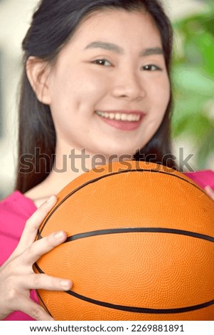 Smiling Minority Female Athlete With Basketball