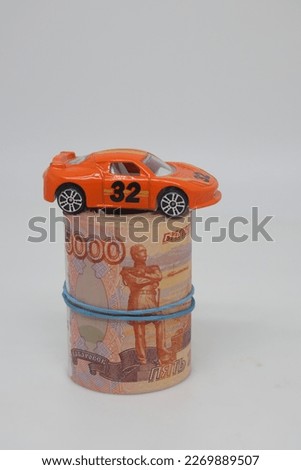 Concept of buying a car. Toy car and banknotes on a white background with copy space