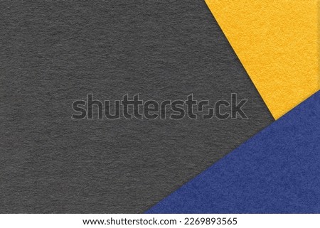 Texture of craft black color paper background with yellow and navy blue border. Vintage abstract cardboard. Presentation template and mockup with copy space. Felt backdrop closeup.
