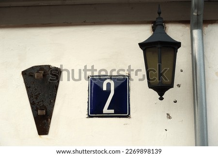 The second number on the wall of the old house.
