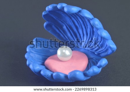 open sea shell with white pearls cartoon molded from plasticine 3d model of blue color on a dark background artificial object for use in icons illustrations and more 