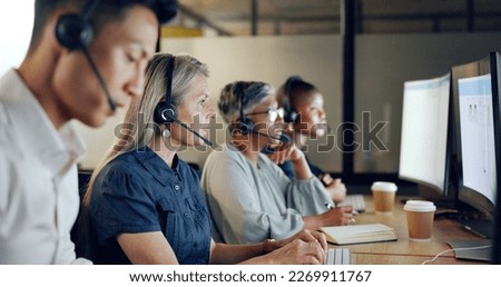 Senior call center consultant, woman and contact us, CRM and talking in customer service, computer at desk. Phone call, telemarketing and diversity, writing in notebook in coworking space and headset Royalty-Free Stock Photo #2269911767