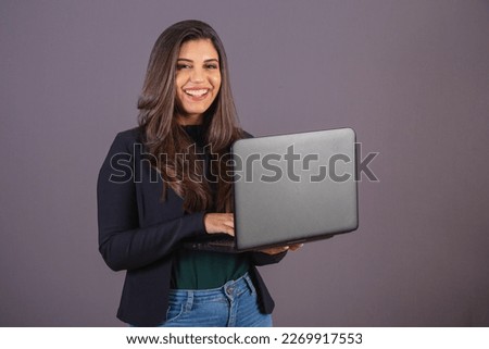 Horizontal photo. Beautiful Brazilian woman in casual clothes, black blazer jeans. with notebook.