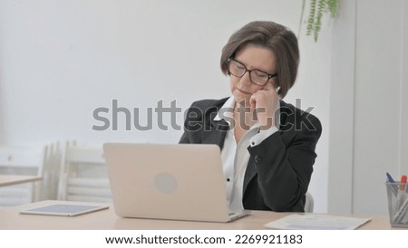 Old Senior Businesswoman Sleeping while Sitting at Work