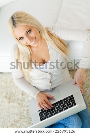 Beautiful girl working on laptop at home.