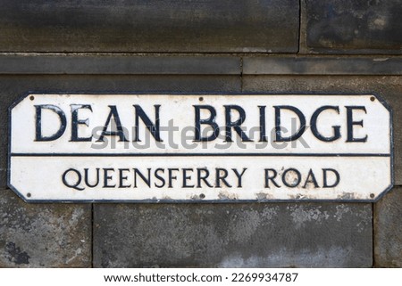 A street sign on the historic Dean Bridge in Edinburgh, Scotland, which is part of Queensferry Road.