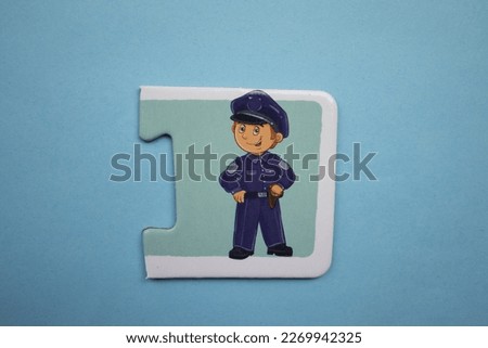 Educational puzzle pieces with colorful police pictures placed on a blue background.