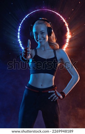 Fit woman Influencer at gym in neon colors. Download photo for advertising a fitness club in social networks. Workout for women at home. Cover for sport motivation music. Runner concept.