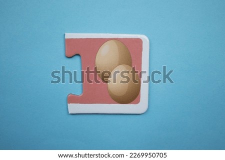 Educational puzzle pieces with colorful egg pictures placed on a blue background.