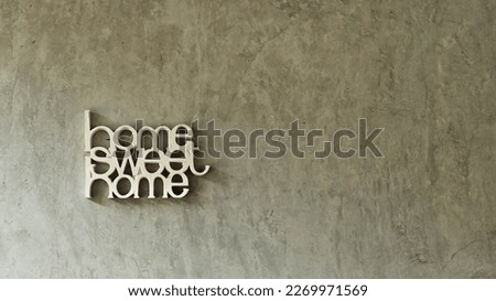 cement wall background with the words home sweet home.