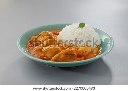 Thai food, Thai chicken red curry with stream rice (panang) in a green plate on grey background.Selective focus. Royalty-Free Stock Photo #2270005493