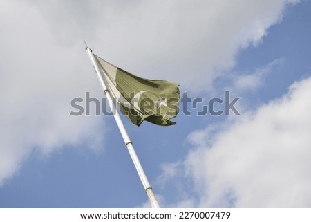 Pakistani flag in blue sky 