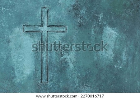 A beautiful simple Christian cross etched into an aged copper metal plate with room for text. Royalty-Free Stock Photo #2270016717
