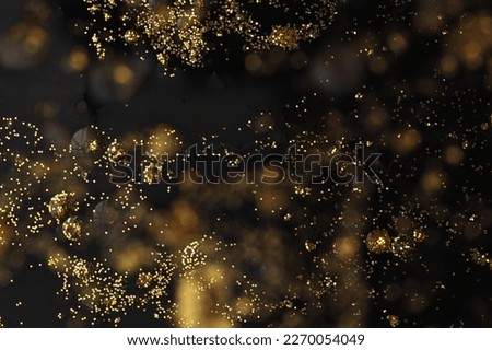 Soft focus Abstract blur black and gold glitter glow shine,texture background.
