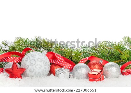 Christmas baubles and red ribbon with snow fir tree. Isolated on white background with copy space