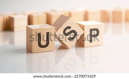 word USP made with wood building blocks, background may have blur effect